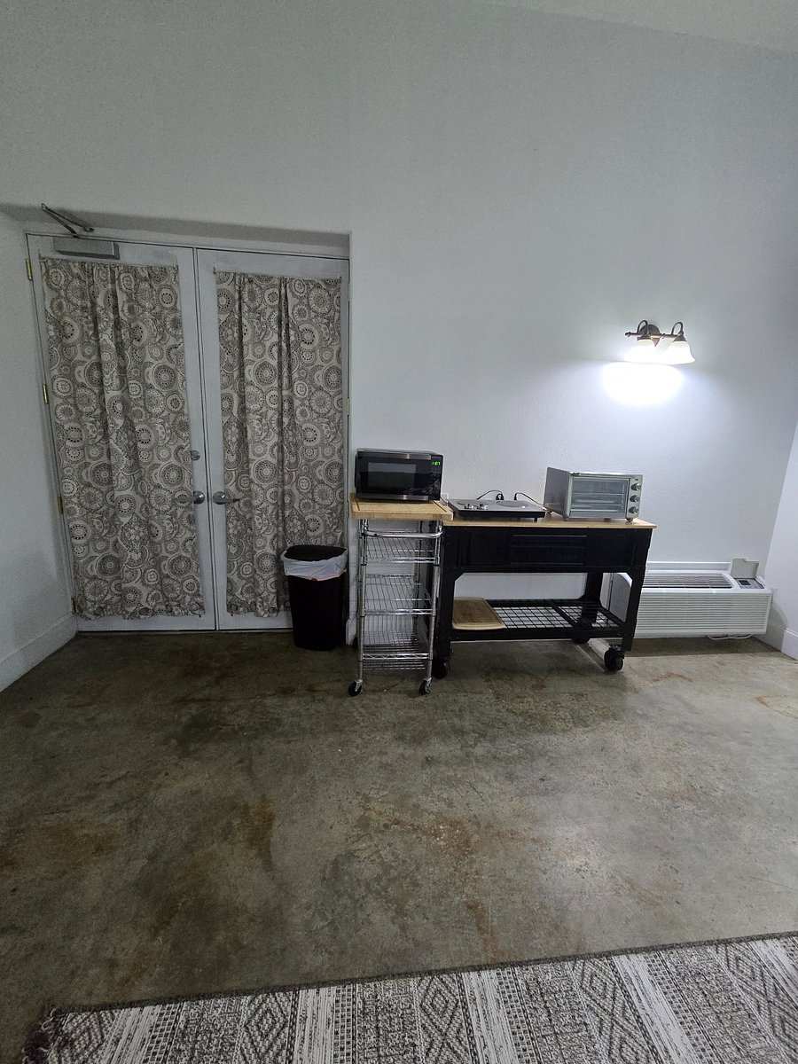 Studio 201: curtained double doors beside the kitchenette carts with a microwave, toaster oven and hot plate.